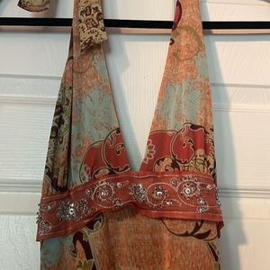 Beautiful halter dress. Light  material with slip. Not see thru.